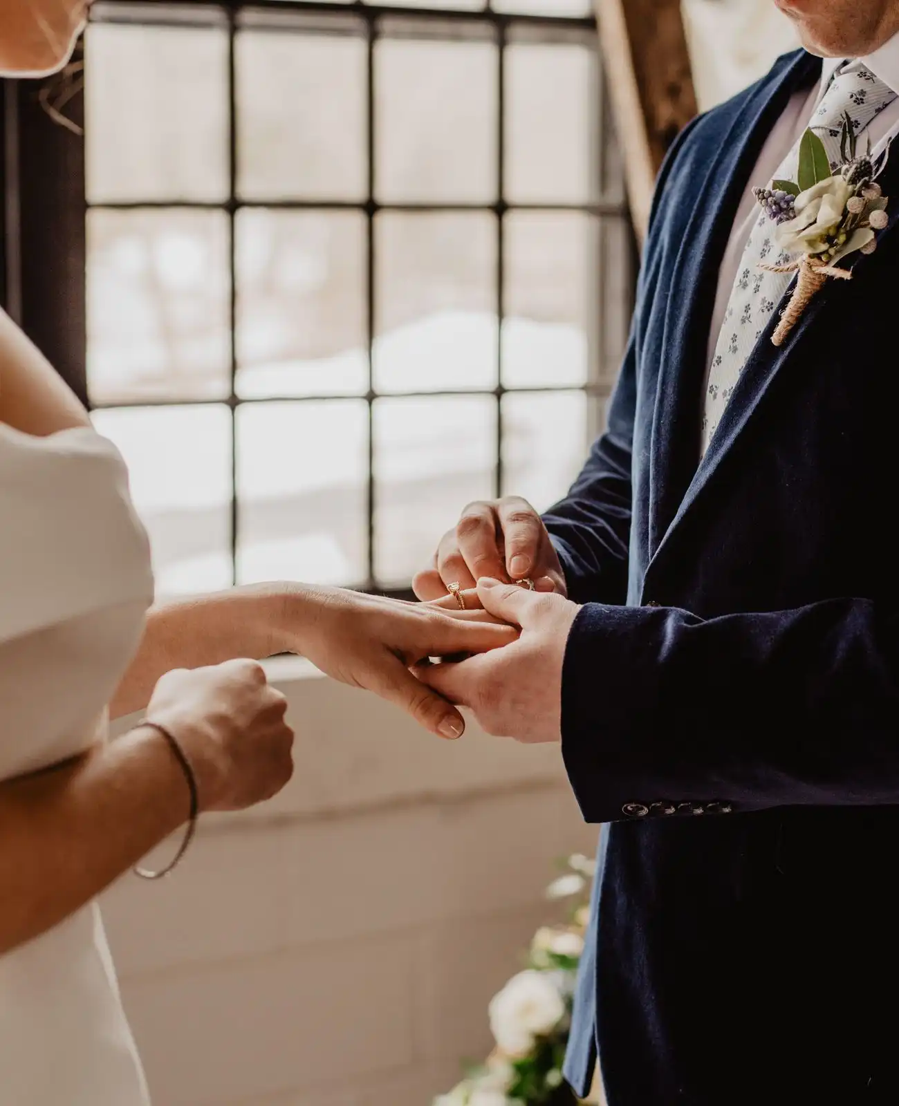 A ring is slid onto the bride&rsquo;s finger during the ceremony.